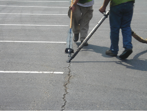 Sealing cracks in asphalt paving extends the life of parking lots and driveways